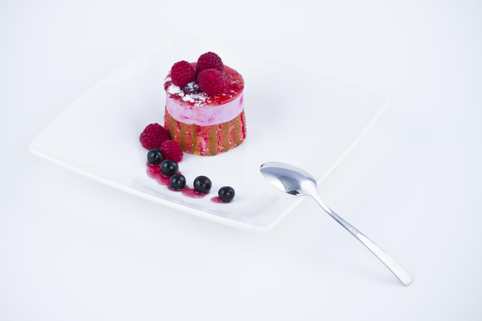 Dessert plated with berry coulis